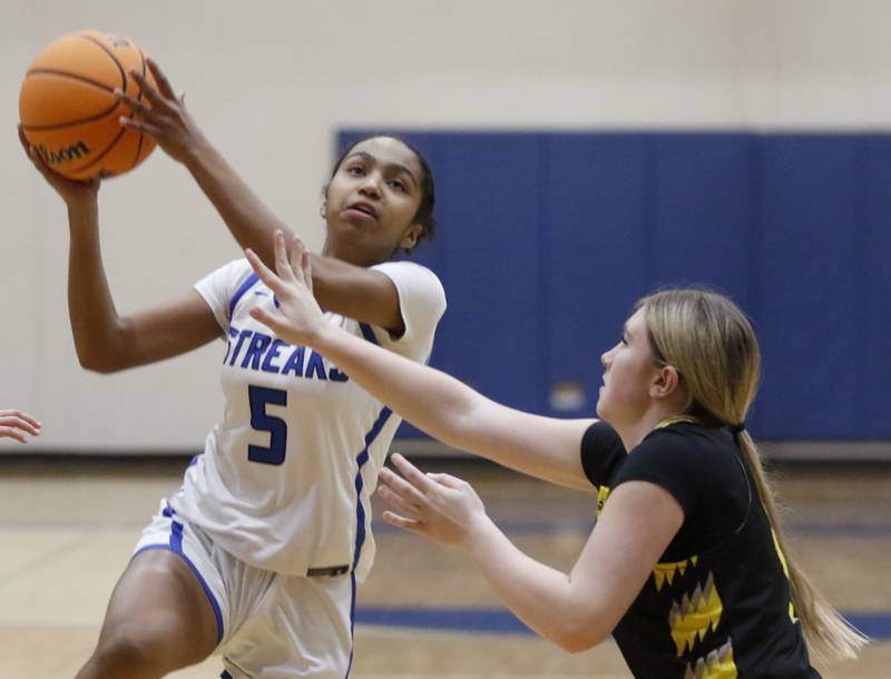 Woodstock's Salome Freites-Alvarado drives the lane against Harvard's Ava Brennecka during a Kishwaukee River Conference girls basketball game on Monday Jan. 12, 2026, at Woodstock High School.