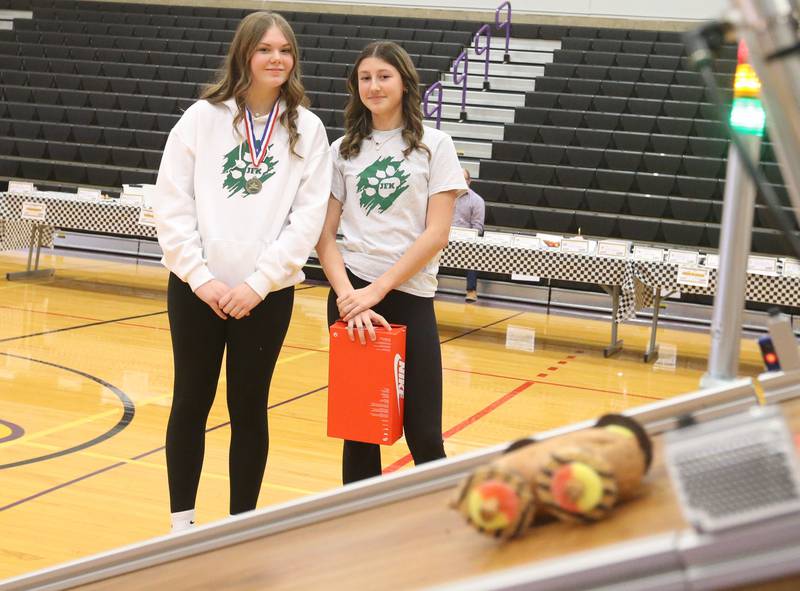 Kirah Struck and Keira Parker, eighth graders at JFK School in Spring Valley, watch their car speed down the ramp during the Edible Car Contest on Wednesday, Feb. 25, 2026 at Illinois Valley Community College in Oglesby.
