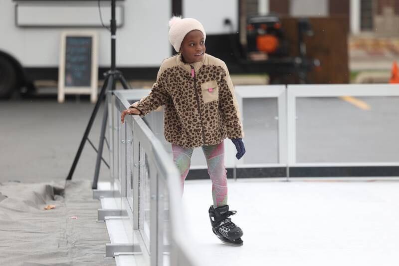 Paige White, 8, stakes on the ice rink set up at North Pole Park at the Joliet Light Up the Lights Holiday Festival on Friday, Nov. 29, 2024.