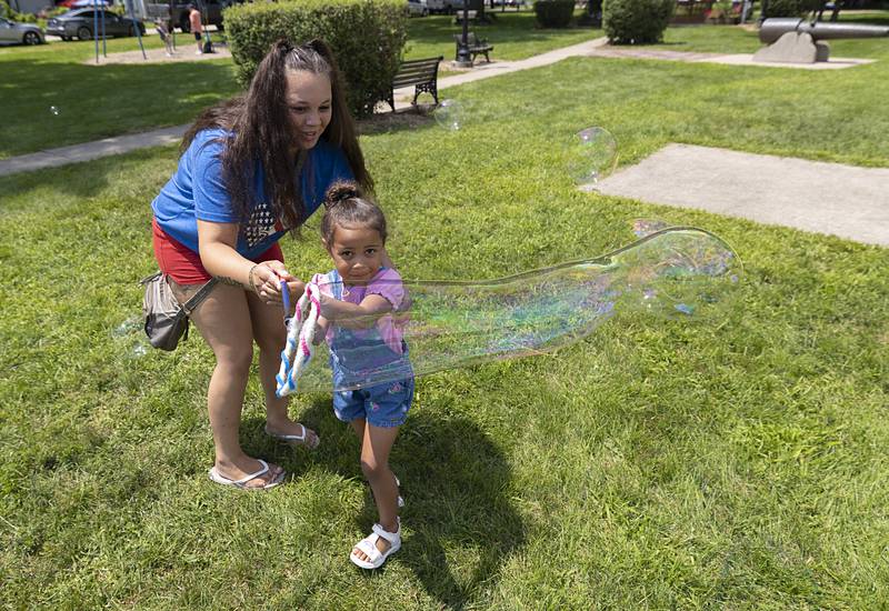 Alexis Norem and Ariella, 3, have fun with bubbles Sunday, July 21, 2024 during Tampico Days. The town celebrated its roots with lots of family friendly activities over the weekend.