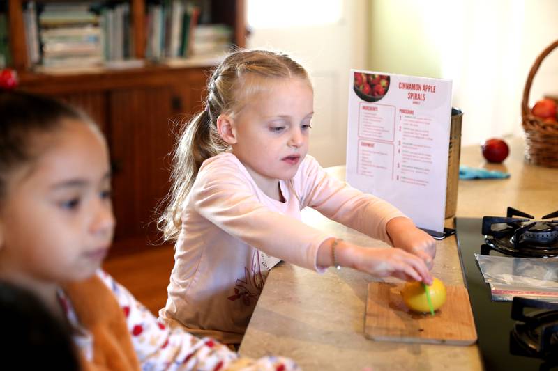 The Learning Door student Amelia Semler, 5, cuts a lemon during a Fun Friday at the Farmhouse School in Campton Hills.