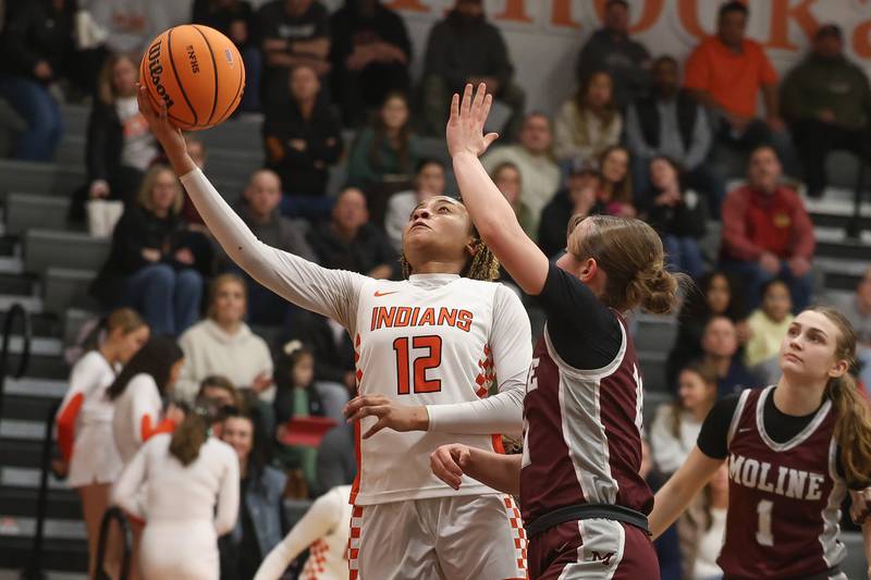 Minooka’s Naya Carter lays in a shot against Moline in the Class 4A Minooka Regional championship game on Thursday, Feb. 19, 2026 in Minooka.