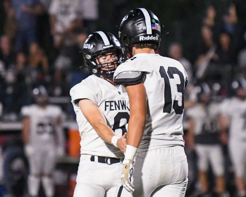Fenwick's Noah Sur (6) gets congratulated by teammate Jonathan Pavalon (13) after Noah’s field goal attempt was good during the game on Friday Sept. 19, 2025, while traveling to take on Montini Catholic High School