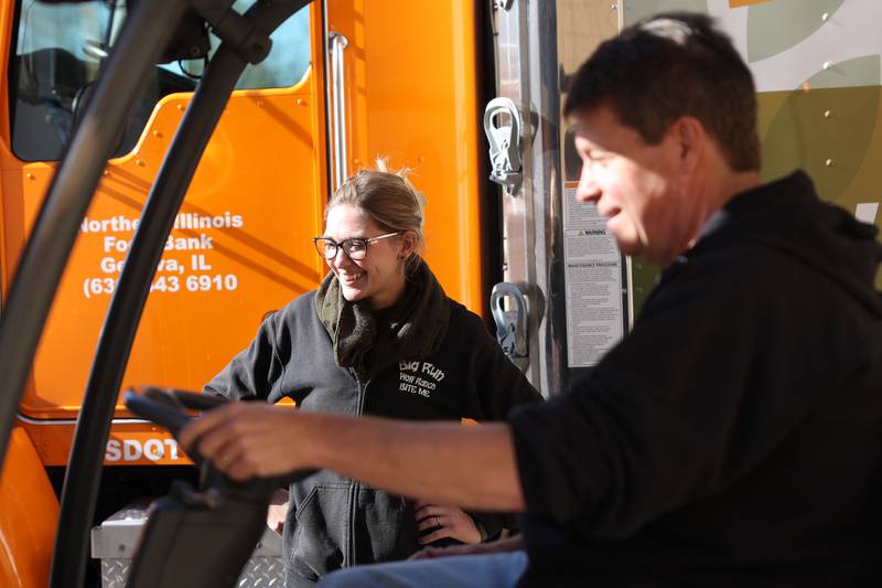 Steve Harold, processing coordinator at the Northern Illinois Food Bank South Suburban Center in Joliet, shares a laugh with Rainah Runty as he loads a pallet of meat for Big Wolf Ranch Rescue in Lockport on Tuesday, Nov. 12, 2024 in Joliet.