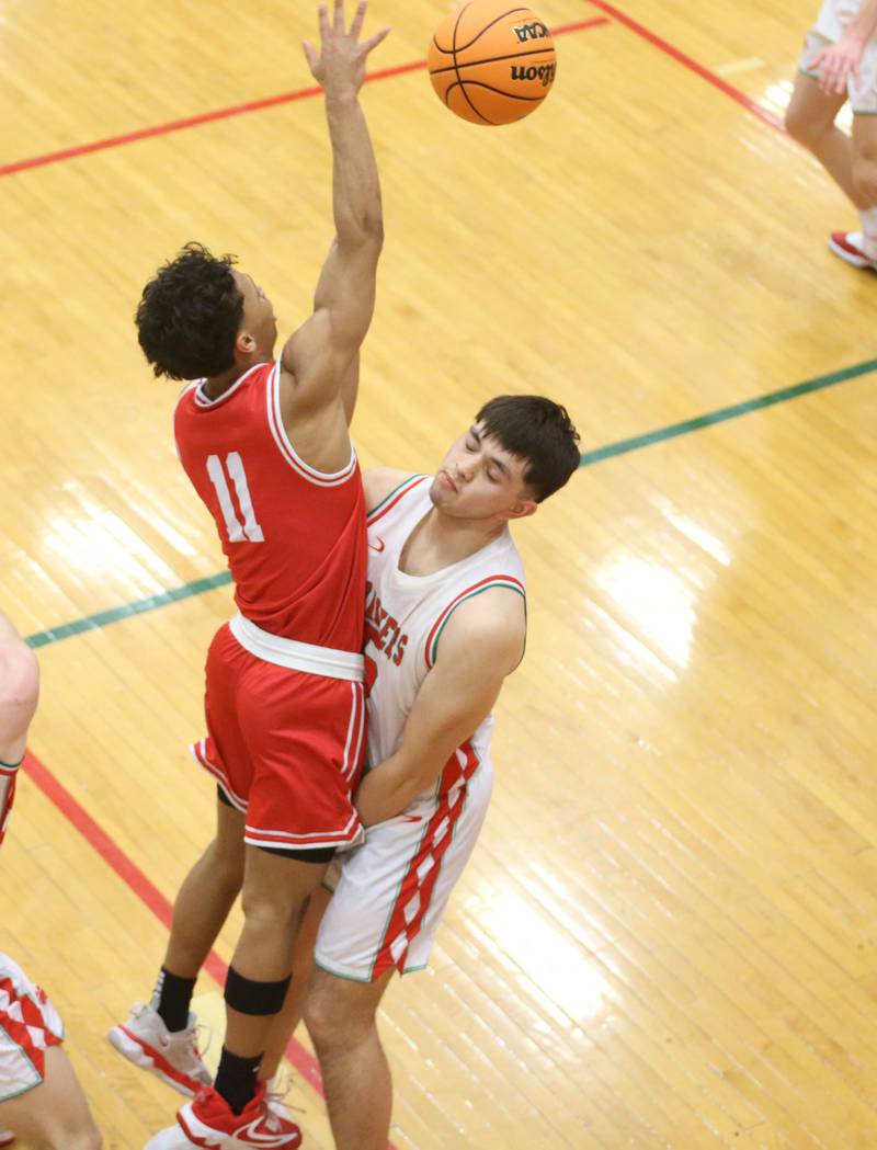 Ottawa's Hezekiah Joachim draws an offensive foul on L-P's Erick Sotelo while passing the ball off during the Class 3A Regional title game on Wednesday, Feb. 25, 2026 in Sellett Gymnasium at L-P High School.