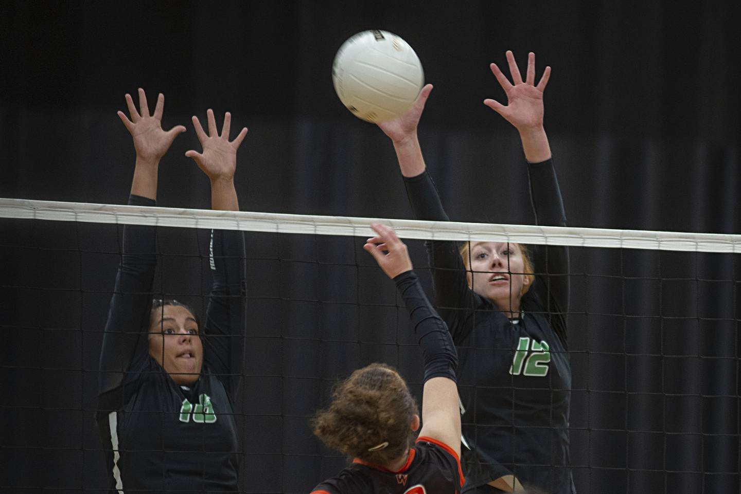 Rock Falls’ Taylor Reyna and Emily Lego go up to block a shot against Winnebago Tuesday, Sept. 27, 2022.