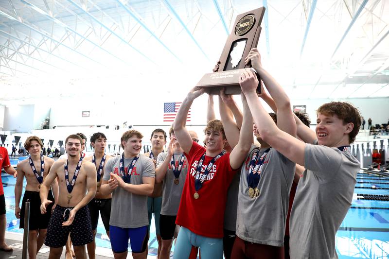 Hinsdale Central swimmers celebrate their first-place finish in the IHSA Boys State Championships on Saturday, March 1, 2025 at the FMC Natatorium in Westmont.