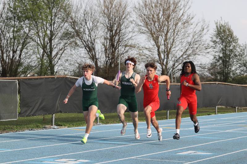 Bradley-Bourbonnais and Bishop McNamara runners execute hand-offs in the boys 4x100 relay during the All-City meet at Kankakee High School on Monday, April, 28, 2025. Bradley-Bourbonnais would take first place with 42.56 seconds ahead of Bishop McNamara's 45.47 seconds.