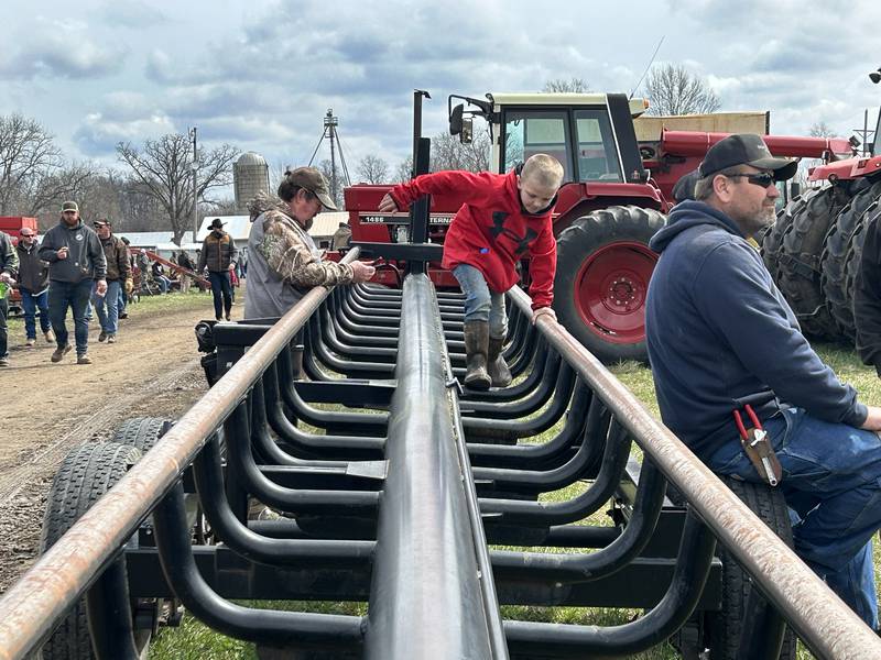 Cayson Wolf, 7, of Dixon, climbs on a round bale hauler on Saturday, April 5, 2025 at the Hazelhurst Spring Consignment Auction. Cayson was at the sale with his dad.
