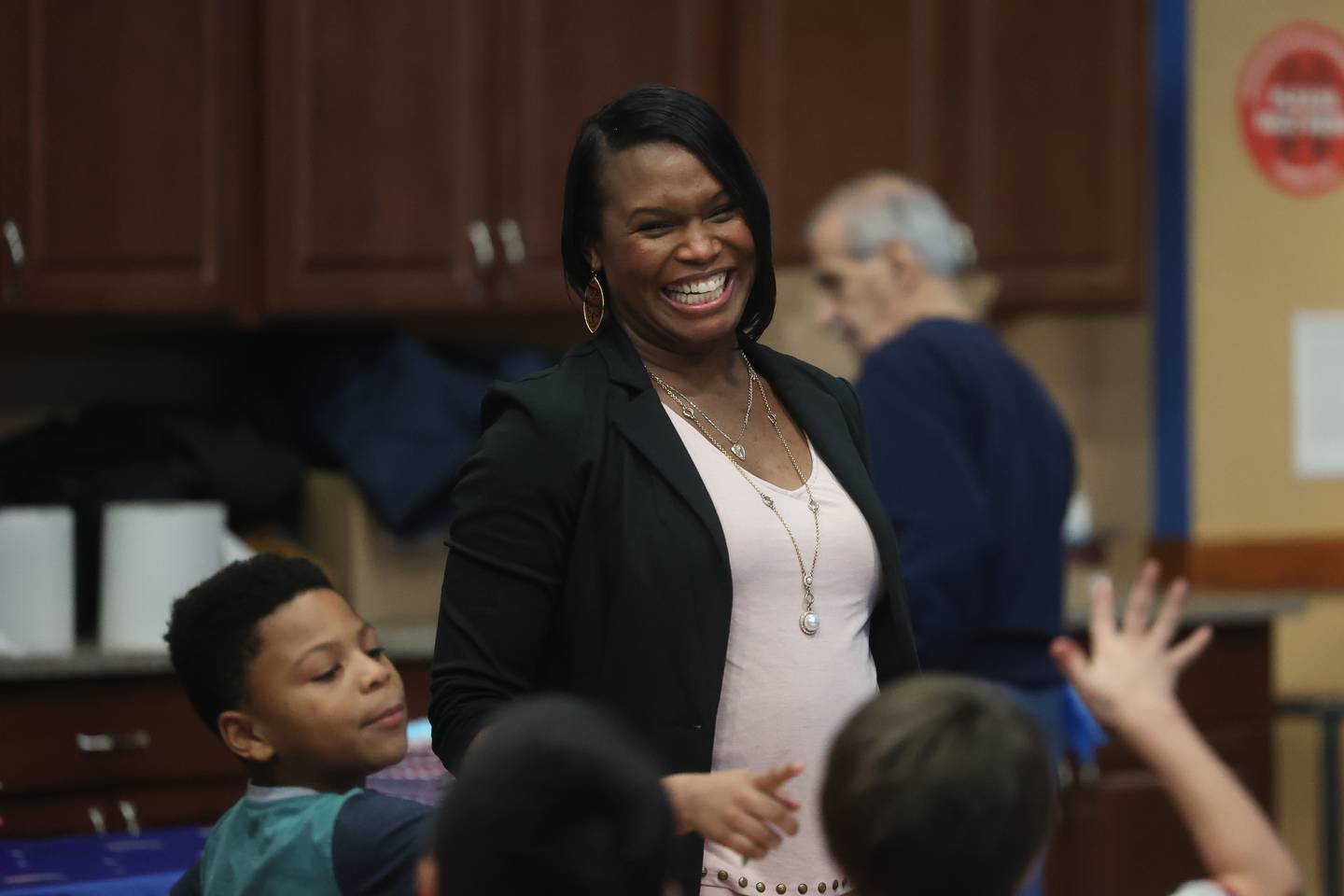 Chantel Gamboa, executive director at the Boys & Girls Club Joliet, has a laugh with the kids at the Boys & Girls Club Joliet pizza party on  Saturday, Dec. 18, 2023.