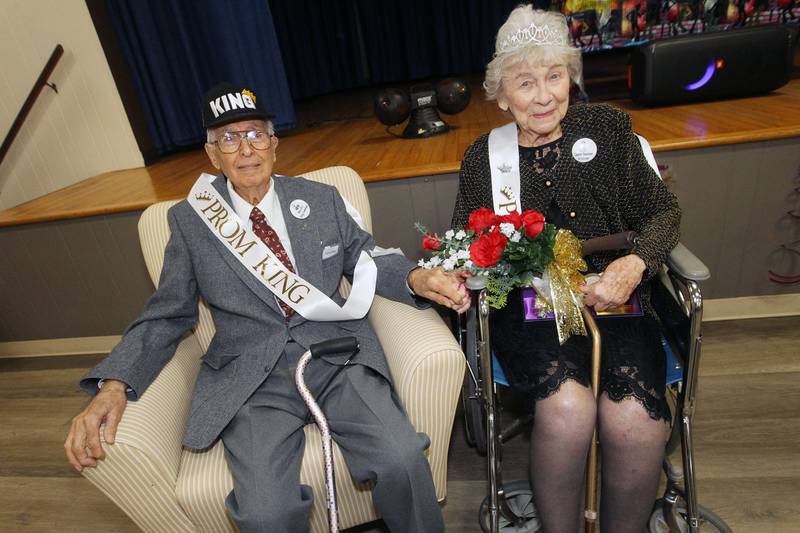 Bob and Vivian Anderson hold hands as they sit together after being crowned Prom King & Queen during the Senior Prom to celebrate the 50th Anniversary of Leisure Village in Fox Lake.The couple have been married for seventy-one years.
