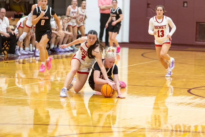 Benet's Sailer Jones  battles for the loose ball with St. Charles East's Addie Schilb at the Montini Christmas Tournament on Tuesday, Dec.23,2025 in Lombard.