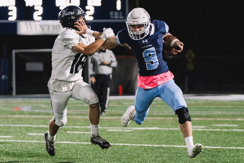 DePaul Prep running back Nick Martinez stiff-arms a Fenwick player during the Rams' 44-43 win. Photo courtesy Seyoum Asefa/DePaul Prep Athletics