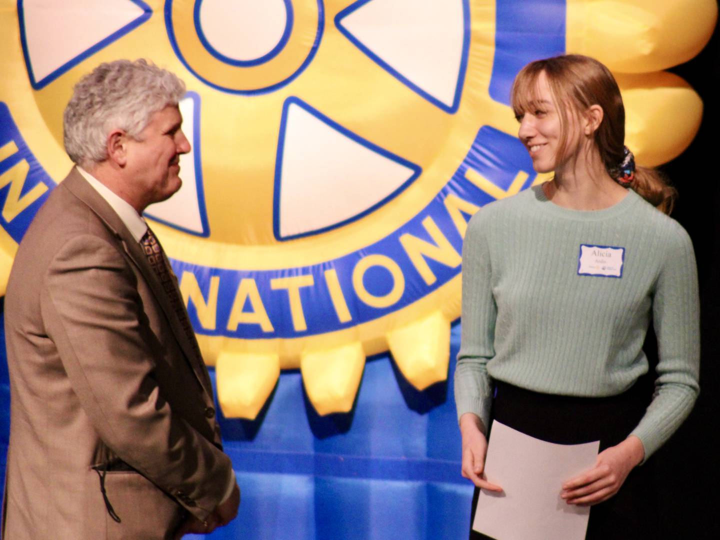 David Hellmich, president of Sauk Valley Community College, greets Newman senior Alicia Ardis on stage Wednesday evening during the 37th Sterling Noon Rotary Student Excellence Program held at Centennial Auditorium.