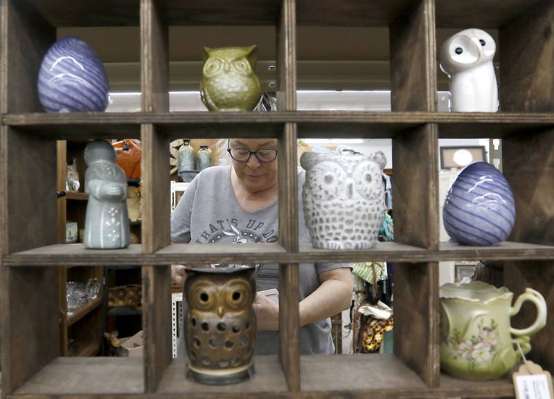 Nance Lopotko of the Eclectic Avenue booth in Q'Tiques in McHenry works  Tuesday, March 4, 2025, on preparing for this weekend's Shop Hop. More than 300 vintage and antique shops are participating in Wisconsin and Illinois.