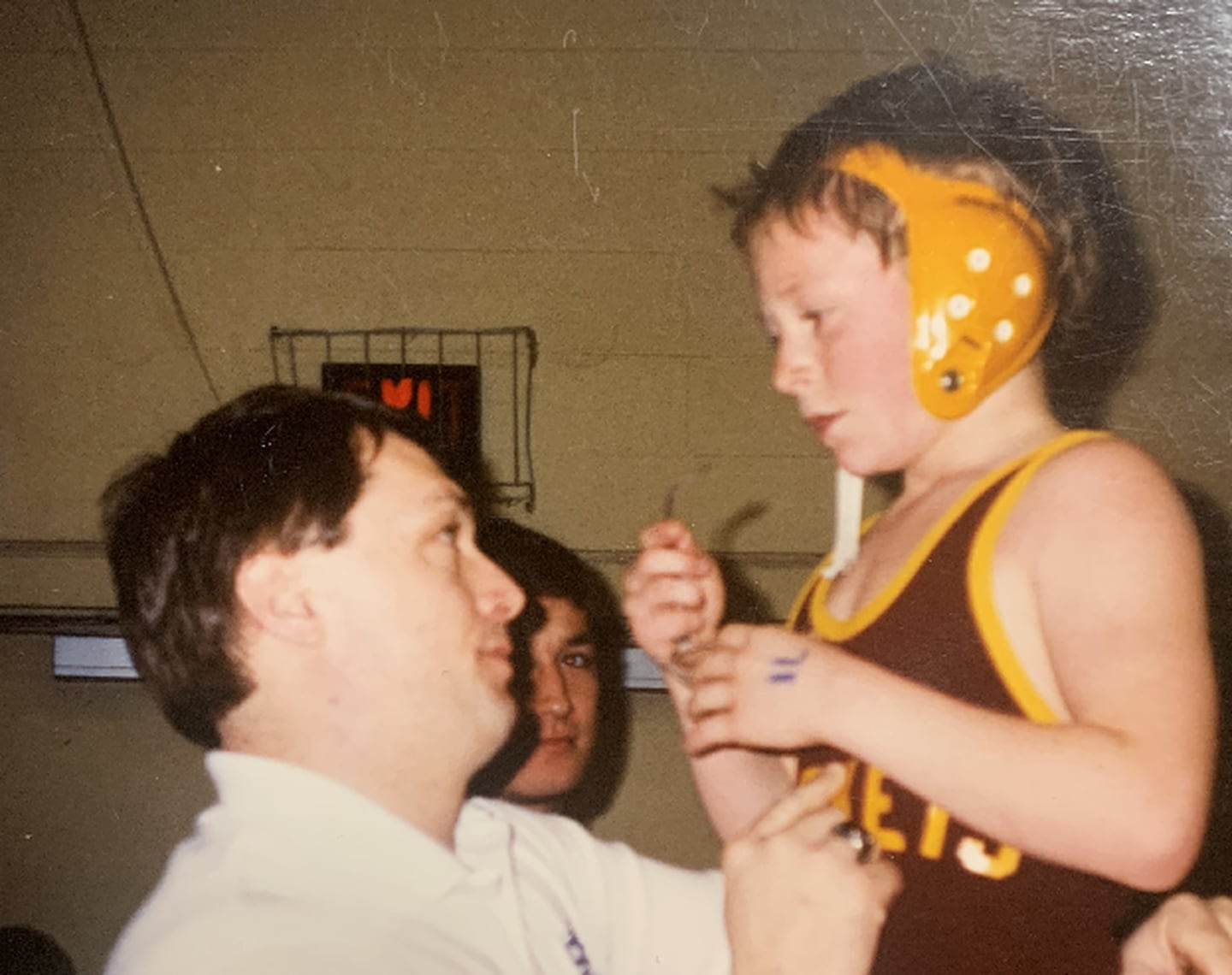 Princeton High School wrestling coach Steve Amy, about age 9 in this photo, gets instructions from his dad, Rick, during a youth match 30 years ago. Rick Amy died in 2021, but left a legacy with his son, who has coached at PHS since 2008.