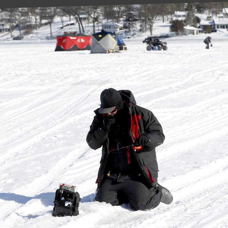 Trevor Janes, who owns Wet N Wild Outfitters, ice fishes Friday, Feb 3. 2023, on Petite Lake near Fox Lake.