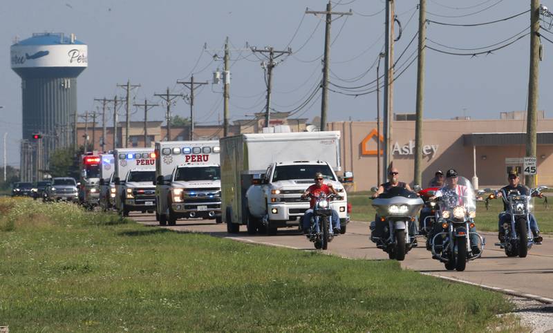 Vietnam Veterans, Peru EMS and Fire and volunteers and other dignitaries ride in motorcycles lead a procession down Peoria Street for the Vietnam Traveling Memorial Wall on Thursday, Aug. 24, 2023 on in Peru.