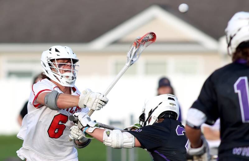 Huntley’s Justin Jacobsen passes the ball against Hampshire in varsity lacrosse at Huntley Thursday night.