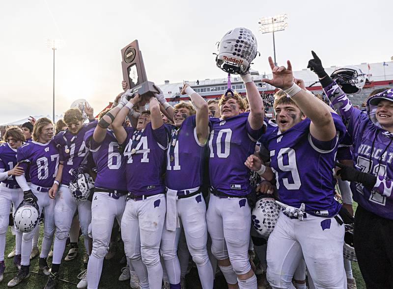 The Wilmington Wildcats celebrate their 28-3 win over Athens Friday, Nov. 24, 2023 in the 2A state football championship game at Hancock Stadium in Normal.