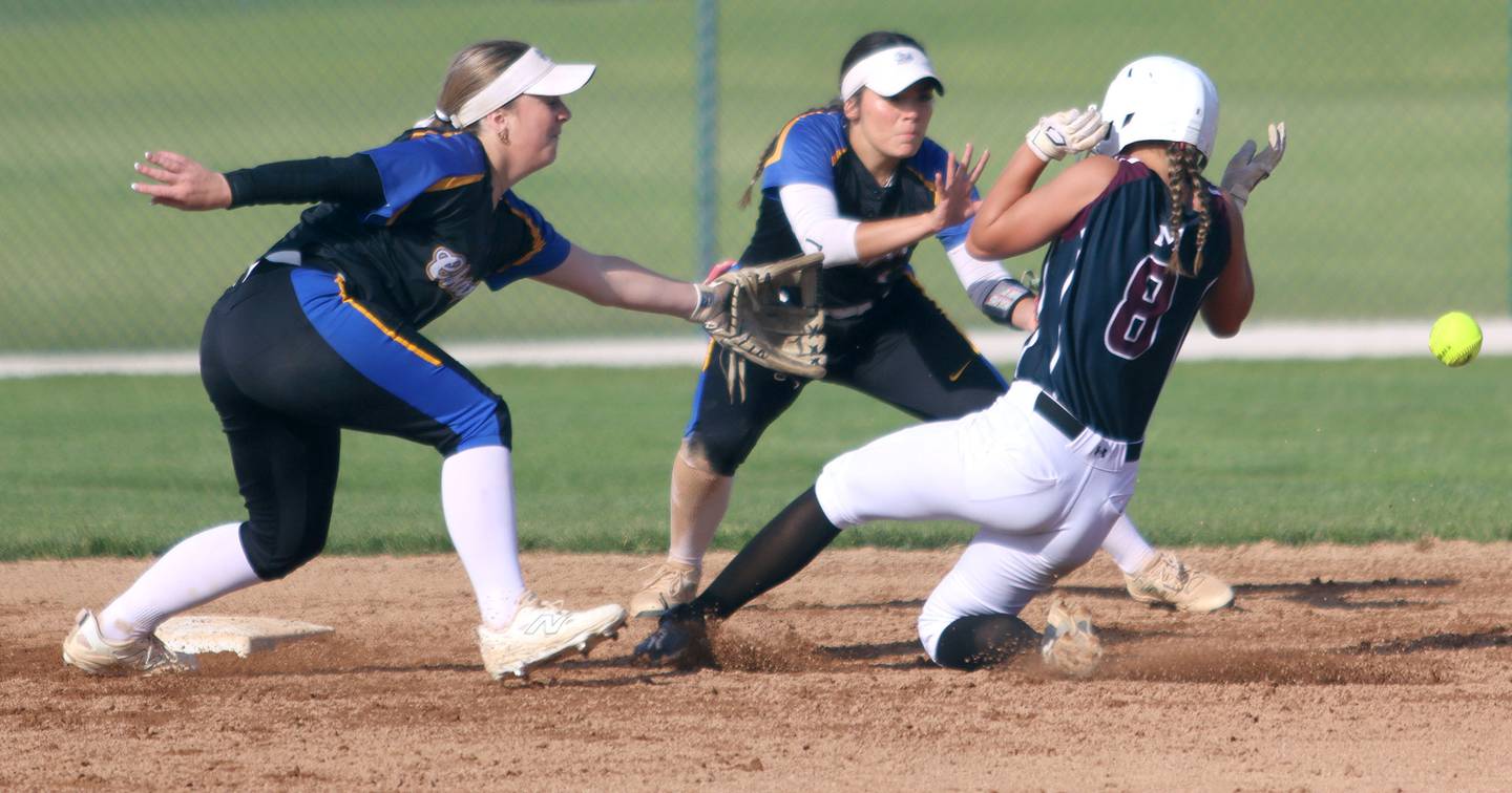 Marengo’s Gabrielle Gieseke, right, slides safely into second base as Aurora Central Catholic’s Morgan Vaghy, left, and Sophia Delgado, center, look for the ball in IHSA Class 2A Regional Title Game action softball at Marengo High School in Marengo on Friday, May 23, 2025.
