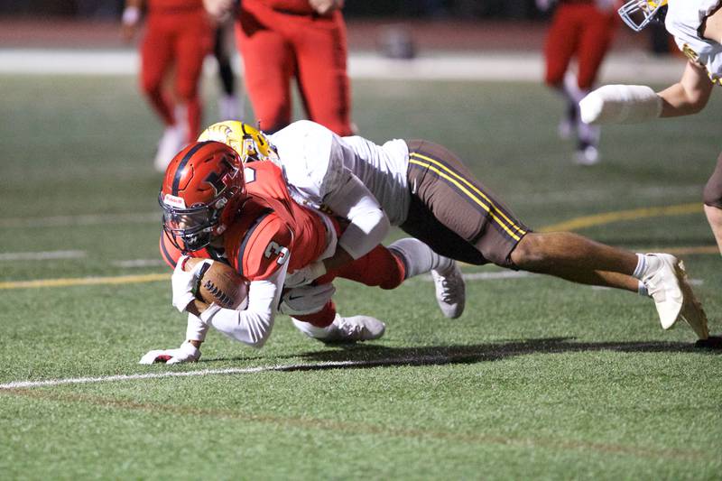 Jacobs Nick Donald tackles Huntley's Omare Segarra on Friday, Sept. 23,2022 in Huntley.