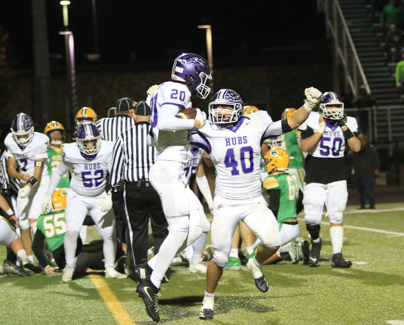 Rochelle's Holden Liebhaber (20) and Roman Villalobos (40) celebrate a player during Friday's Class 4A first-round playoff game at Geneseo.