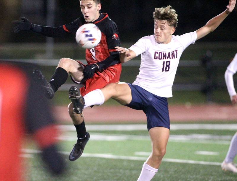 Glenbard East’s Zachary Pfister (left) and Conant’s Oliver Wozny go after the ball during a 3A St. Charles East Sectional semifinal on Wednesday, Oct. 26, 2022.