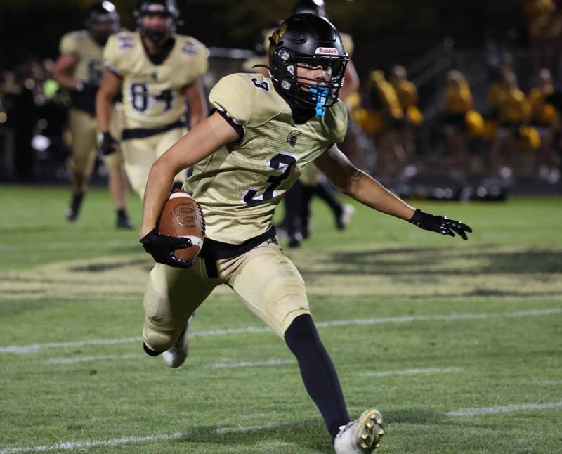 Sycamore's Benjamin Anderson carries the ball after making a catch during their game against Rochelle Friday, Sept. 19, 2025, at Sycamore High School.