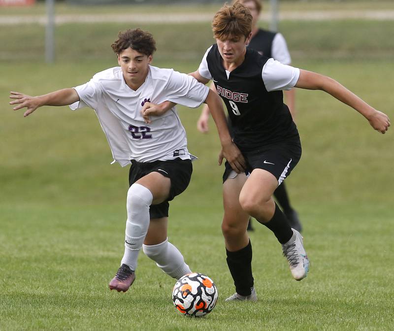 Hampshire's Lukianos Petropoulos and Prairie Ridge's Matthew Fireng battle for the ball during a Fox Valley Conference soccer match Tuesday, Sept. 19, 2023, at Prairie Ridge High School in Crystal Lake.