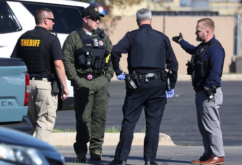 Law enforcement officers talk Wednesday, Oct. 23, 2024, outside of the Brian Bemis Toyota car dealership in DeKalb after responding to a stabbing where multiple employees were injured. The incident ended after police shot the man wielding the knife authorities said.
