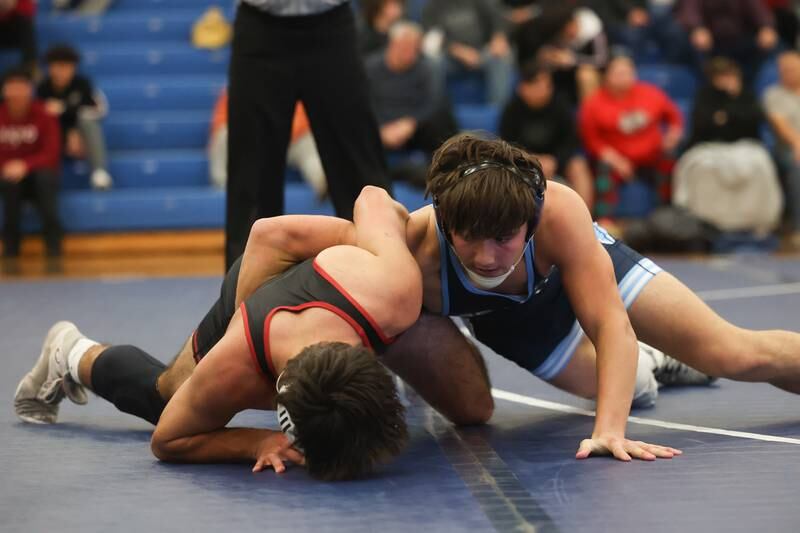 Plainfield South’s Chase Peirceall wraps up Plainfield North’s Sam Zito in a Southwest Prairie dual meet on Wednesday, Nov. 29, 2023 in Plainfield.