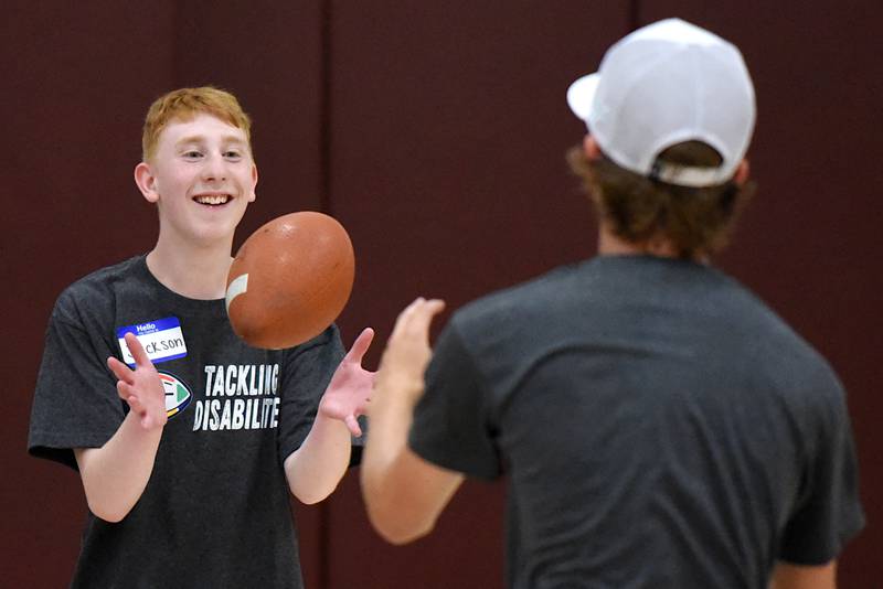 Jackson Dickte, left, catches a pass from David Barwegen during Watseka's Tackling Disabilities football camp Saturday, July 26, 2025.