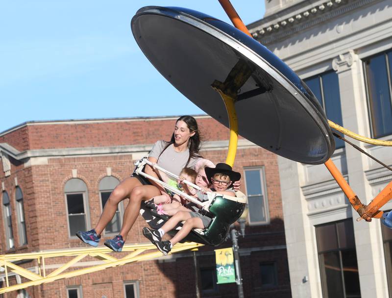 Stacia Hamill, of Dixon, takes a spin on one of the carnival rides at Polo's Town & Country Days on June 18, 2022. With Hammil are Max Miles, 2, Riley Miles, 3, and Aden Schuler, 6, of Polo.