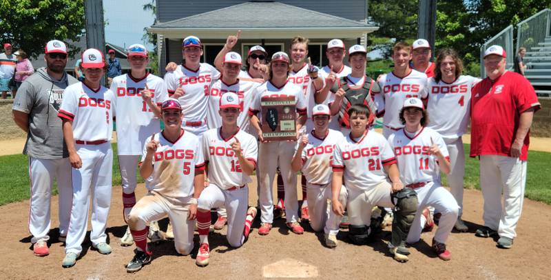 The Streator Bulldogs baseball team gathers at home plate with its Class 3A Geneseo Regional championship plaque following a 7-6 win over Galesburg on Saturday, May 27, 2023.