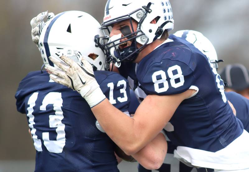 Cary-Grove’s Jackson Berndt, left, is greeted by teammate Quintin Witt after a Berndt touchdown run against Antioch in IHSA Class 6A second-round playoff football action on Saturday, Nov. 9, 2024, at Al Bohrer Field on the campus of Cary-Grove High School in Cary..