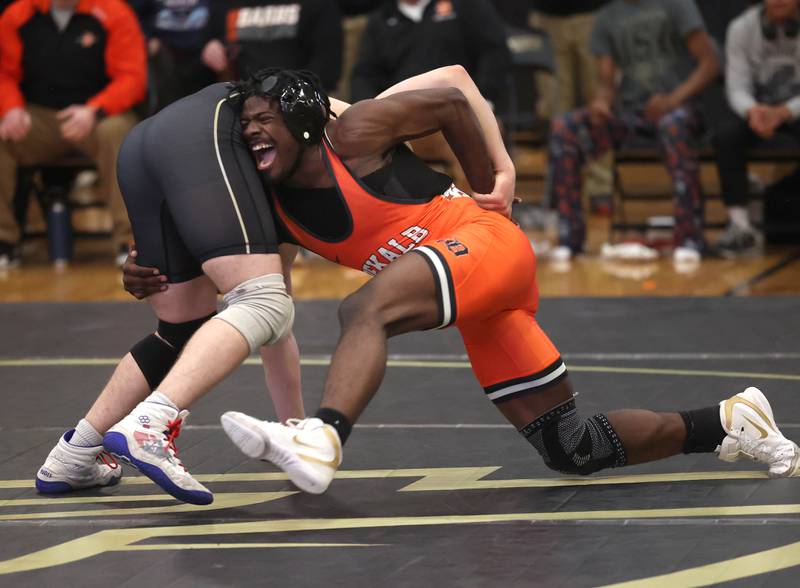 DeKalb’s Cam Matthews shoots on Sycamore’s Douglas Gemberling during their match at 157 pounds Friday, Jan. 16, 2026, at Sycamore High School.
