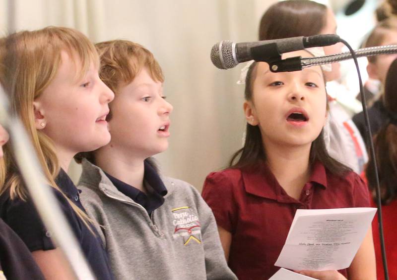 Cora Lehn, Cal Dobrich and Genesis Ramirez sing in the choir loft during the All Schools Mass on Thursday, Feb. 20, 2025 in La Salle. The Most Reverend Bishop Louis Tylka, Bishop of Peoria gave Mass while announcing a new name for the three schools calling it Carlo Acutis. Last year, the Catholic Diocese of Peoria announced the consolidation of the three schools. Carlo Acutis Canonization will take place on Sunday, April 27, 2025 during the Jubilee of Teenagers in Rome. Acutis is the first millennial saint, representing those born between the early 1980's and the late 1990's. He is celebrated for cataloging miracles and online and managing websites for Catholic organizations.