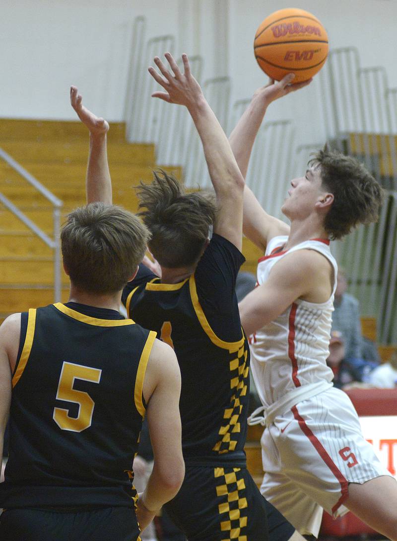 Streator’s Brennen Stillwell shoots over the block attempt of Reed Custer’s Eddie Bryan in the 2nd period Tuesday at Streator.