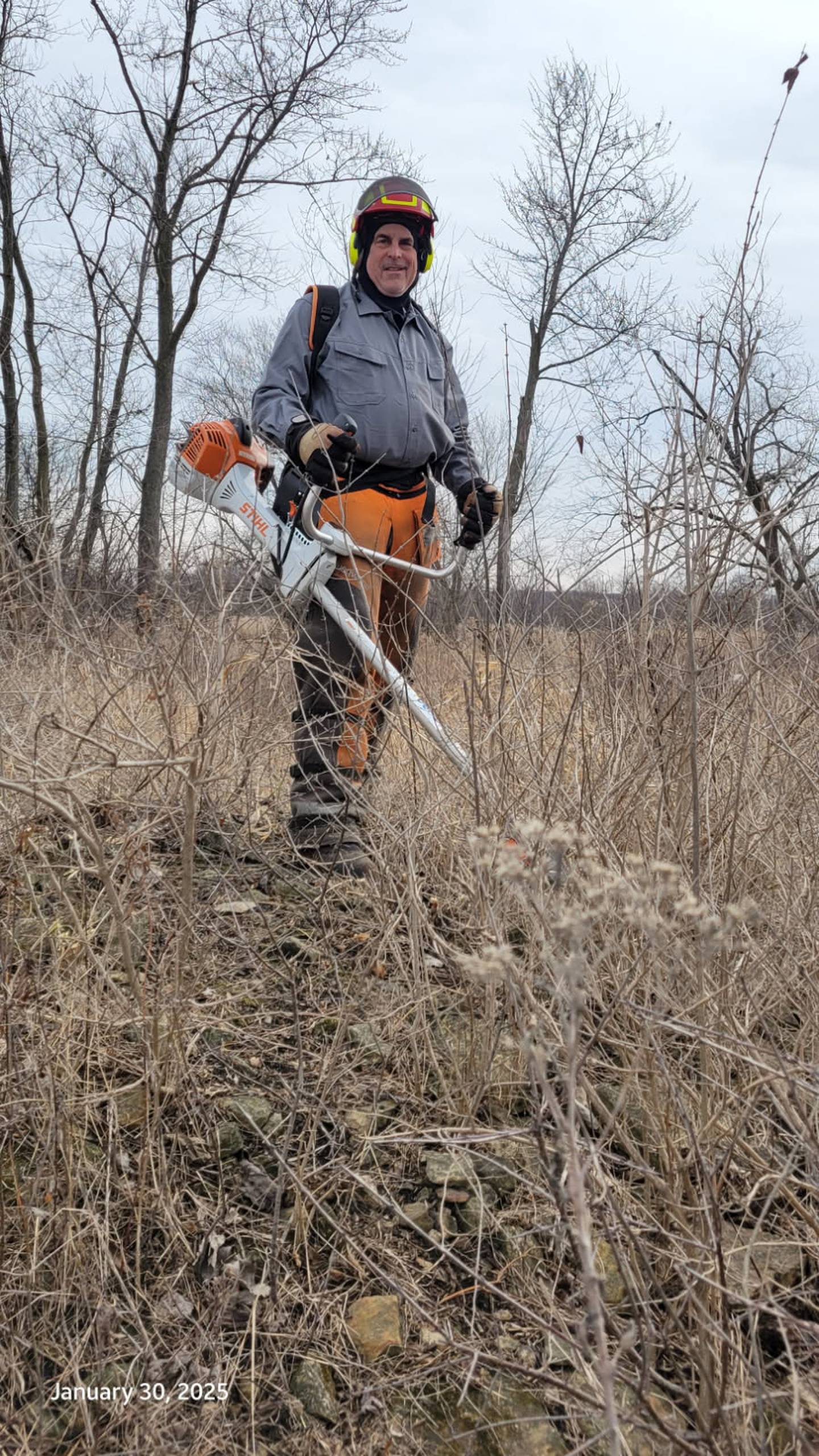 Scott Mortenson works to clear invasive species in a Will County Forest Preserve prairie.