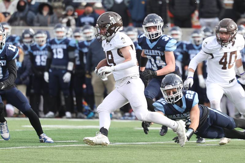 Joliet Catholic’s Keegan Farnaus weaves through the defense on a run against Nazareth in the Class 5A state championship on Saturday, Nov. 30, 2024 in Normal.