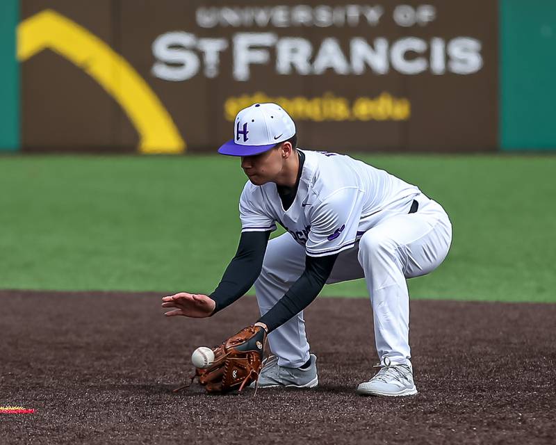 Hampshire's Jaryd Vence (5) looks in a grounder to second during baseball game between Dixon at Hampshire.  March 28, 2024