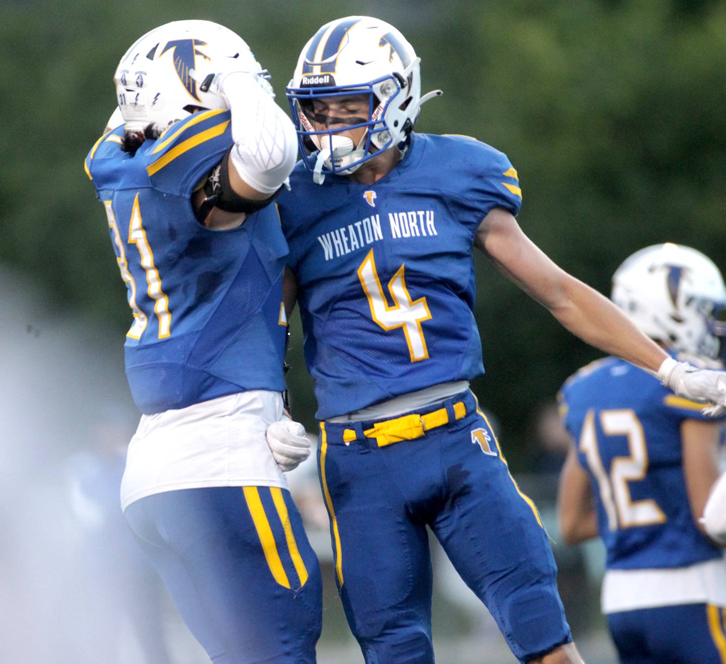 Wheaton North’s Rich Schilling (right) and Dylan Jung (left) celebrate Schilling’s touchdown during a game against St. Charles North in Wheaton on Friday, Sept. 8, 2023.