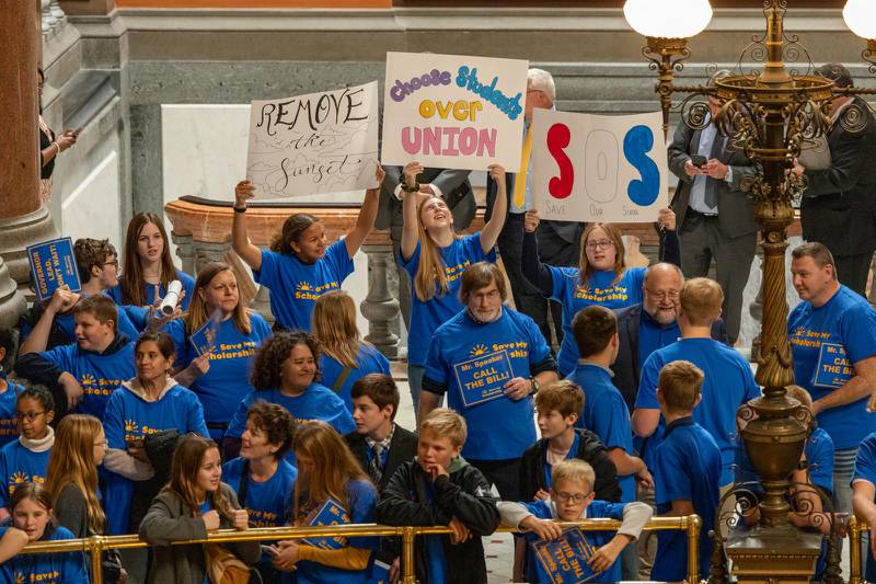 Supporters of the Invest in Kids scholarship program for private schools rally outside the Illinois House of Representatives chamber on Tuesday. Lawmakers adjourned their fall veto session Thursday without voting to renew the program, meaning it will expire on Dec. 31.