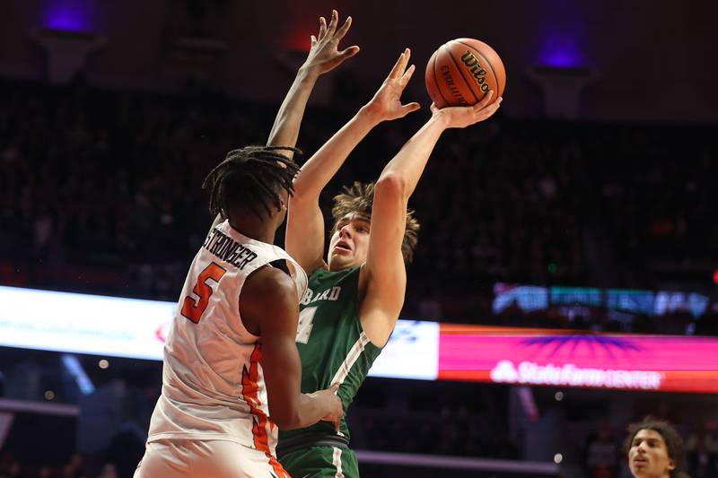 Glenbard West’s Braden Huff puts up a contested shot against Whitney Young in the Class 4A championship game at State Farm Center in Champaign. Saturday, Mar. 12, 2022, in Champaign.