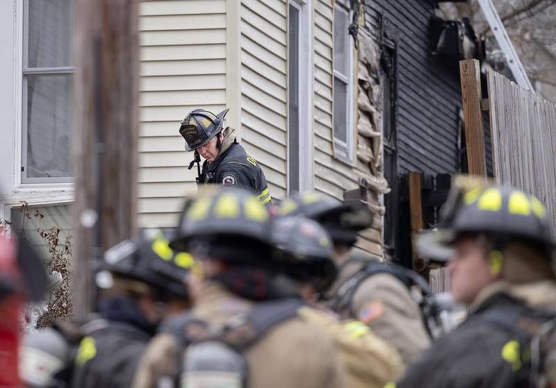 Firefighters work at the scene of a fire located at 712 Madison Ave. in Dixon. A backyard pigpen started on fire and spread to the house. No people were injured, but a pig died.