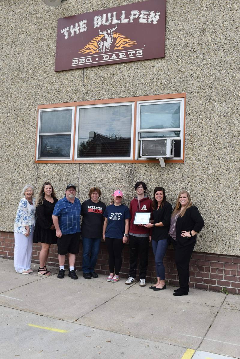 Karen Karpati and Dana Stillwell (Streator chamber board members), Bullpen Owners Brian and Jalyn Mitts, Amanda Plymire, Damon Darrow, Courtney Levy (executive director of the Streator Chamber) and Megan Wright (member services coordinator of the Streator Chamber) pose in front of the Bullpen restaurant after it was named Streator Chamber's May 2022 business of the month.