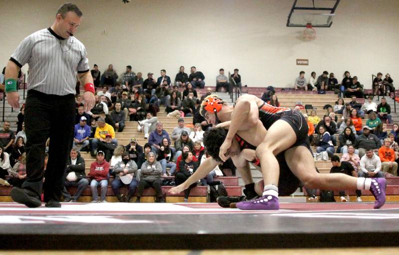 Huntley’s Hersh Suthar (top) battles McHenry’s Armand Paglini at 160 pounds in their Fox Valley Conference dual on Friday in Huntley.