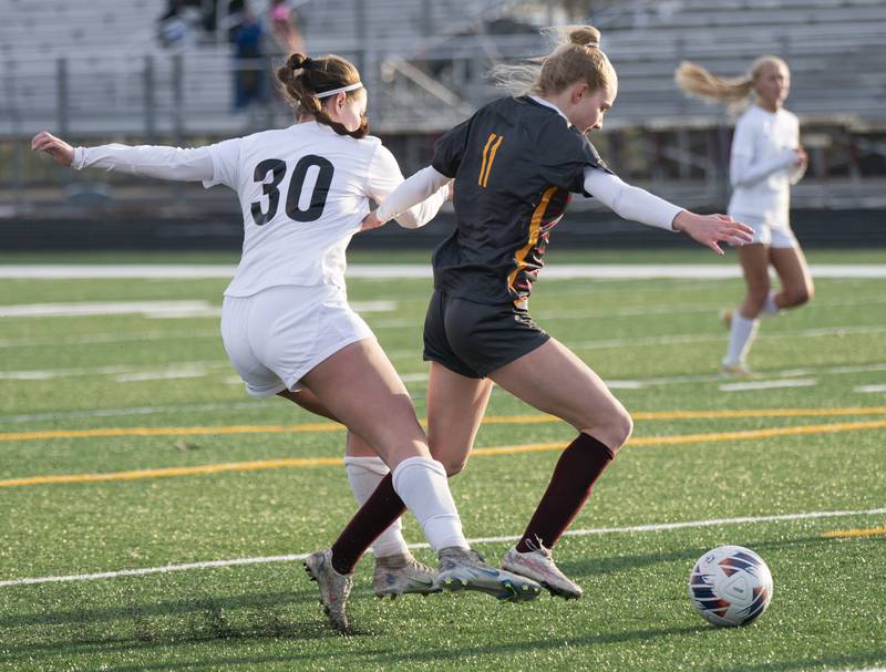 Prairie Ridge's Delanie Shorten gets tripped up with Richmond-Burton's Margaret Slove as they battle for the ball during their game on Wednesday, April 5, 2023 at Richmond-Burton High School in Richmond. Ryan Rayburn for Shaw Local