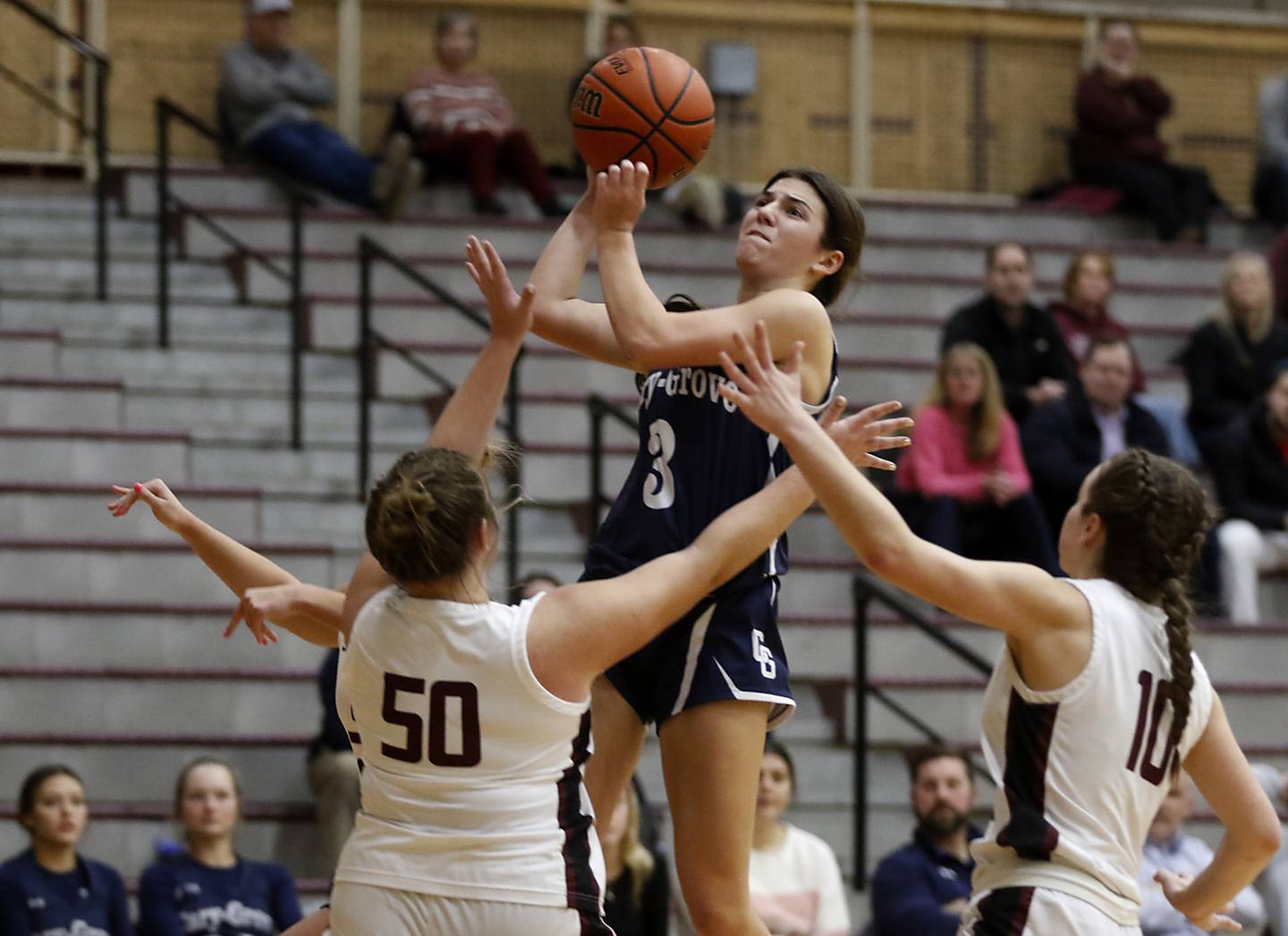 Cary-Grove's Kennedy Manning shoots the ball over Prairie Ridge's Grace Wolf (left) and Ali Storz during a Fox Valley Conference girls basketball game Wednesday, Jan. 17, 2024, at Prairie Ridge High School.